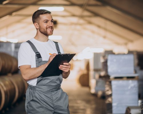 Young handsome man working at a factory
